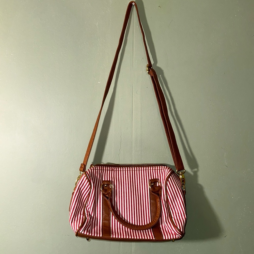 Charming Charlie red and white cross body purse with tan and gold accents